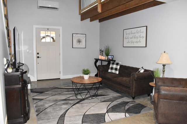 living area featuring beam ceiling, baseboards, and a wall mounted AC