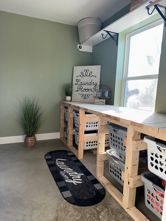 interior space with concrete flooring and baseboards