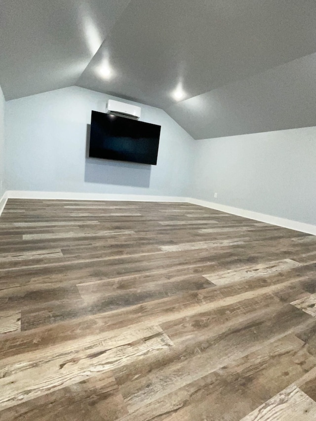 bonus room with lofted ceiling, baseboards, and wood finished floors