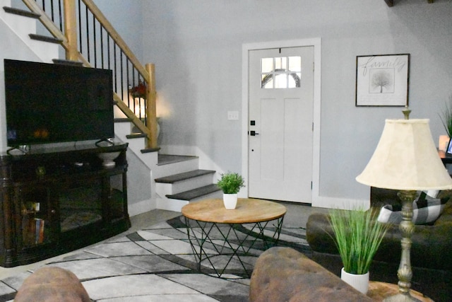 entrance foyer with baseboards and stairway