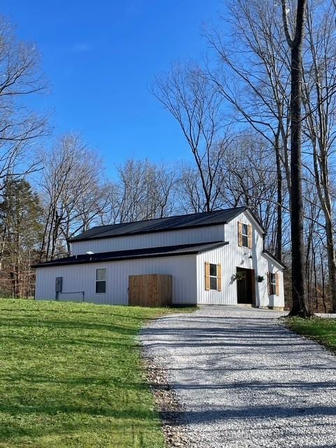 exterior space with driveway and a yard