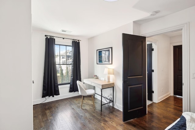 office featuring dark wood-type flooring, visible vents, and baseboards