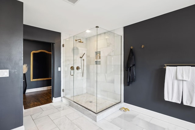 full bathroom featuring a stall shower and baseboards