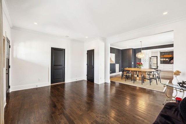 living area with recessed lighting, ornamental molding, wood finished floors, a chandelier, and baseboards