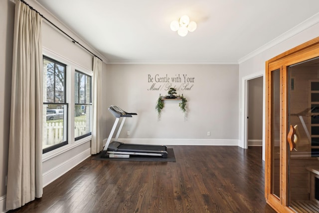 workout area with crown molding, dark wood finished floors, and baseboards