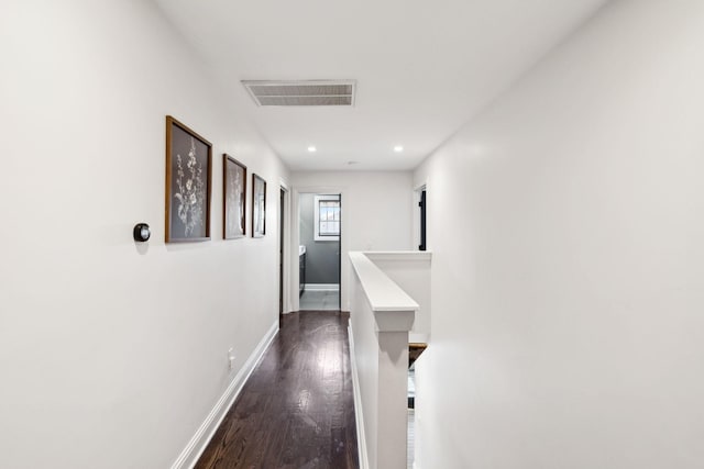 hall featuring recessed lighting, wood finished floors, visible vents, and baseboards