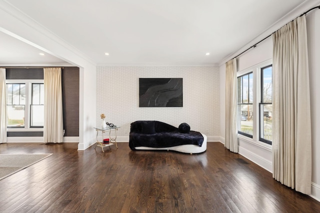 sitting room with baseboards, ornamental molding, dark wood finished floors, and wallpapered walls