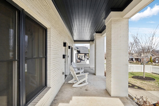 view of patio / terrace featuring a residential view and fence