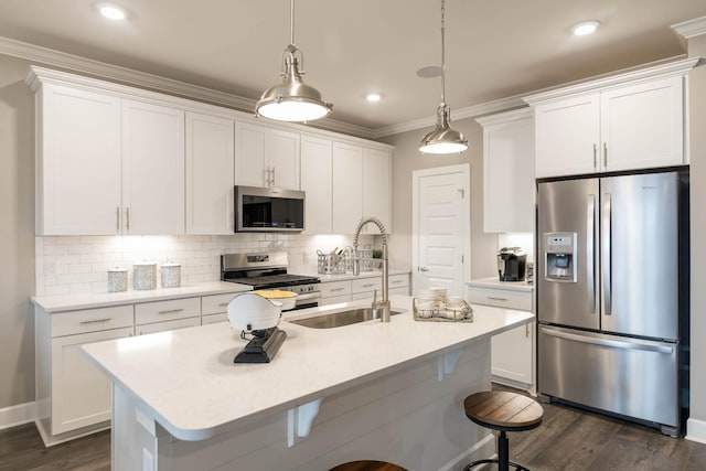 kitchen featuring stainless steel appliances, pendant lighting, light countertops, and white cabinetry