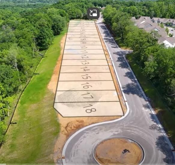 bird's eye view with a wooded view