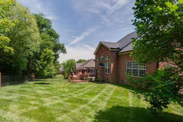 view of yard with fence and a wooden deck