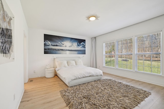 bedroom featuring wood finished floors and baseboards