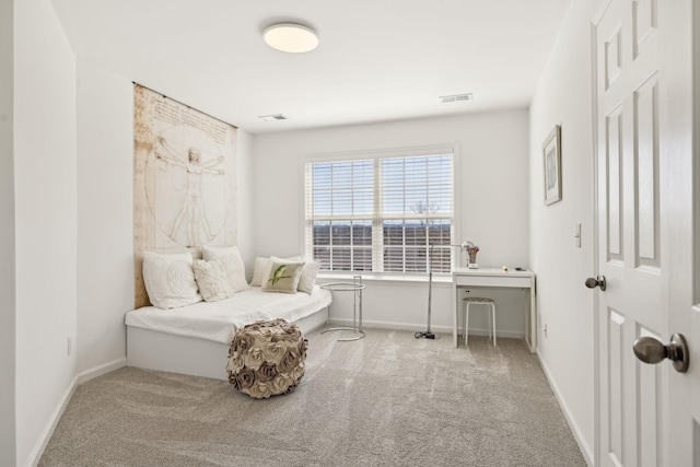 sitting room featuring baseboards, visible vents, and light colored carpet