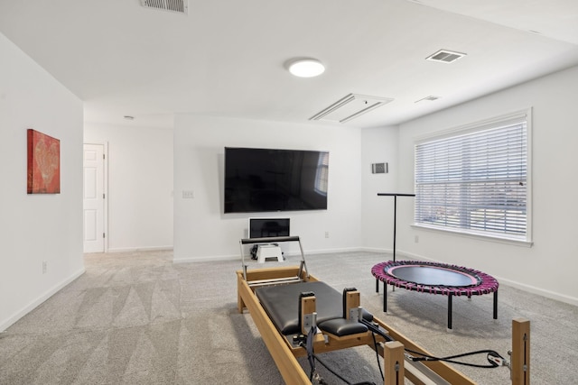 workout room with light carpet, visible vents, and baseboards