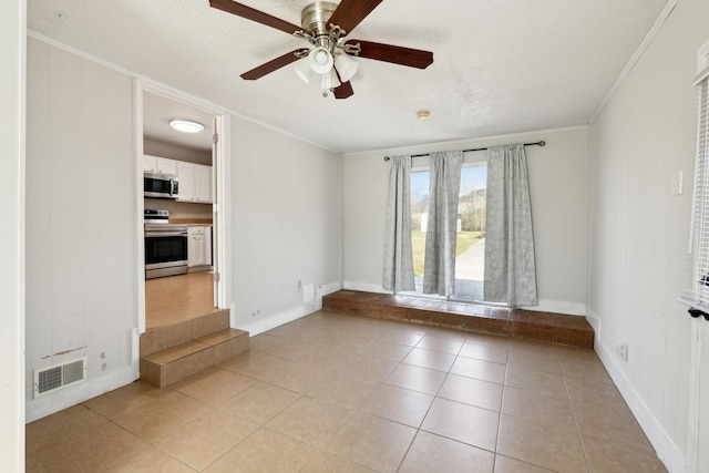 empty room featuring ornamental molding, light tile patterned flooring, visible vents, and baseboards