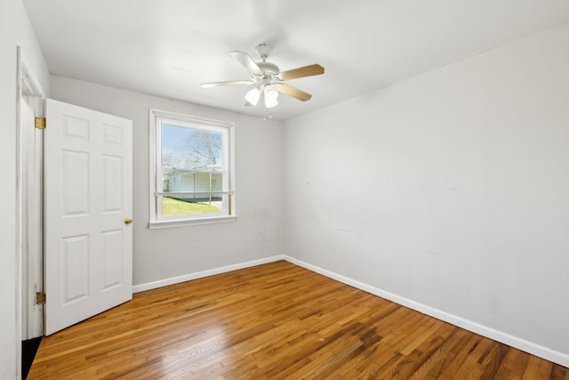 unfurnished bedroom featuring wood finished floors, a ceiling fan, and baseboards