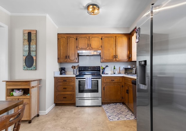 kitchen featuring light countertops, appliances with stainless steel finishes, brown cabinetry, and under cabinet range hood