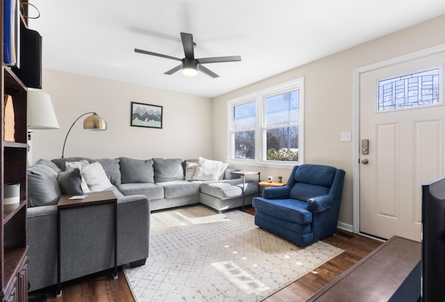 living area with dark wood finished floors and a ceiling fan