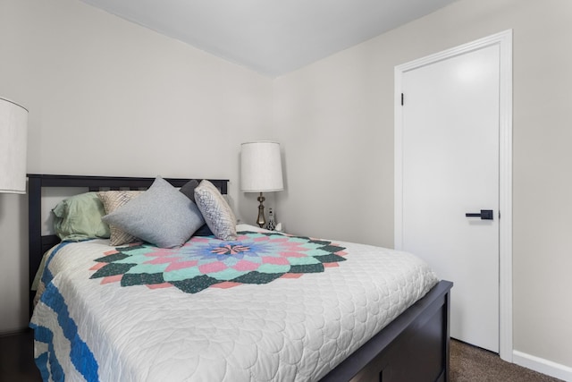 bedroom featuring dark carpet