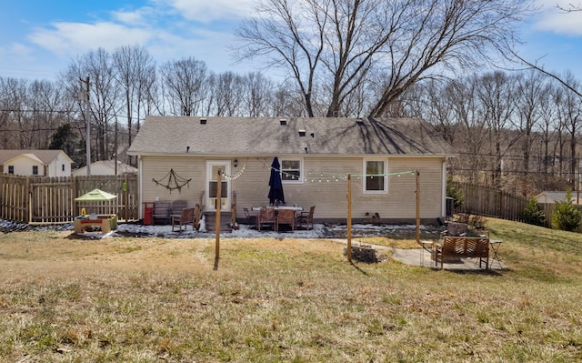 rear view of house featuring entry steps, a patio, a fire pit, fence, and a yard