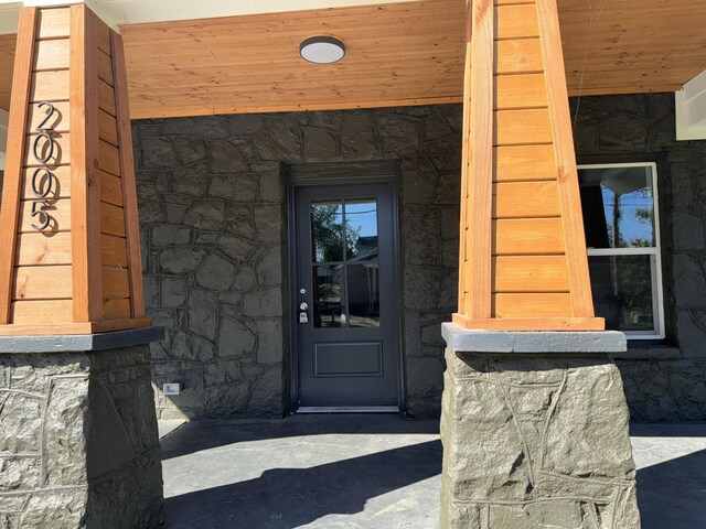 entrance to property with stone siding