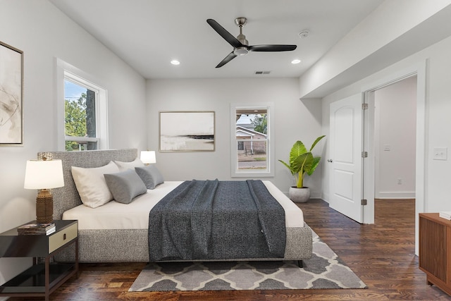 bedroom with recessed lighting, multiple windows, dark wood finished floors, and visible vents