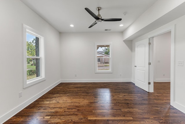 interior space with a healthy amount of sunlight, baseboards, visible vents, and dark wood-style flooring