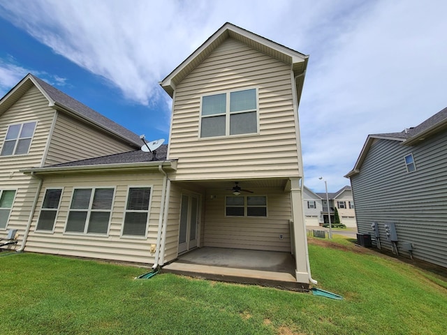 back of house featuring central AC, a patio, a lawn, and a ceiling fan