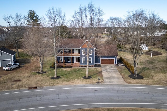 view of front of home with concrete driveway, an attached garage, and a front lawn