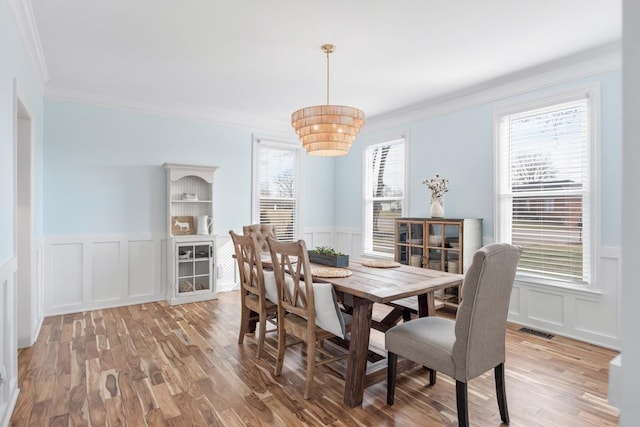 dining room with visible vents, a wealth of natural light, and wood finished floors