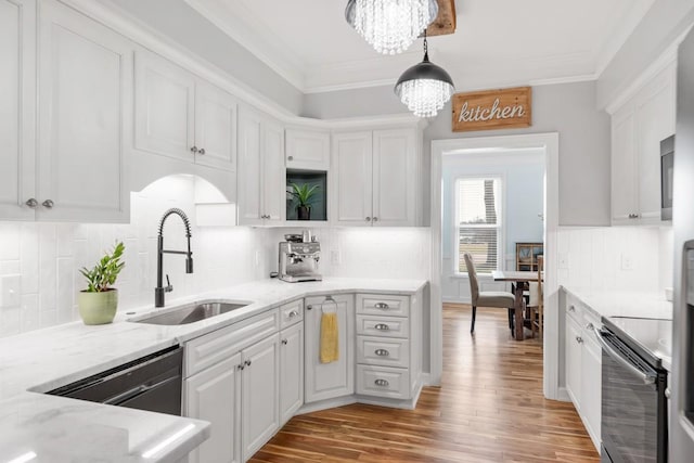 kitchen featuring a chandelier, black / electric stove, a sink, and crown molding