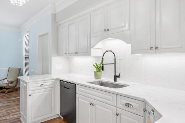 kitchen with dishwasher, wood finished floors, crown molding, white cabinetry, and a sink