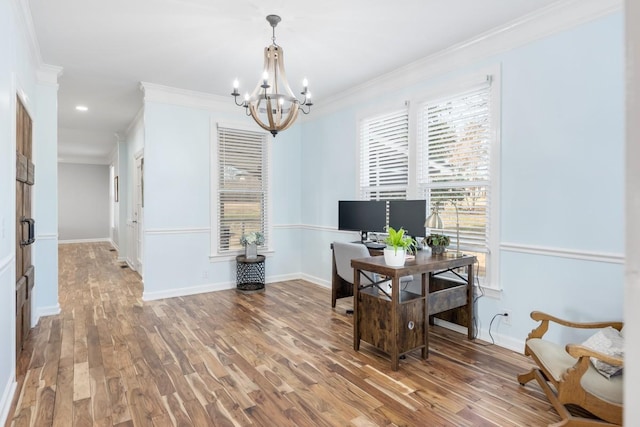 office space featuring baseboards, a notable chandelier, wood finished floors, and crown molding