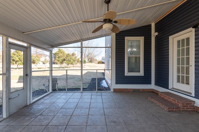 unfurnished sunroom featuring ceiling fan and vaulted ceiling