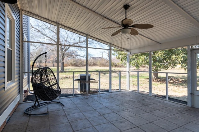 unfurnished sunroom with a ceiling fan