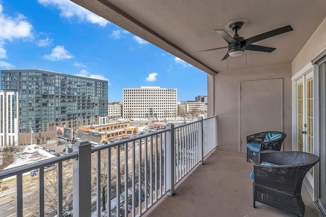 balcony featuring ceiling fan and a view of city