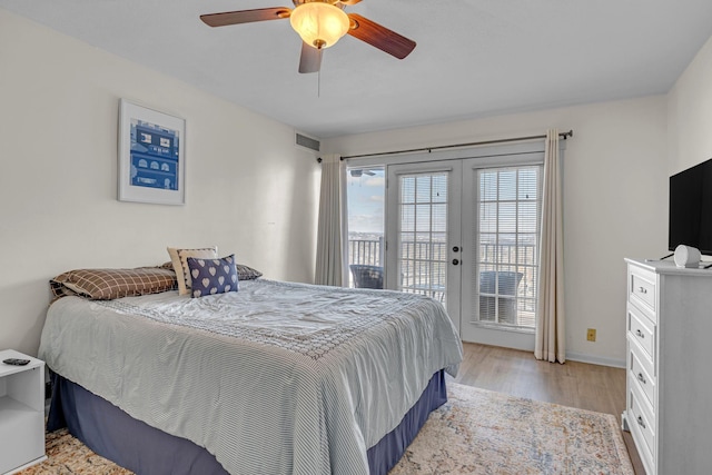 bedroom with ceiling fan, visible vents, light wood-style floors, access to exterior, and french doors