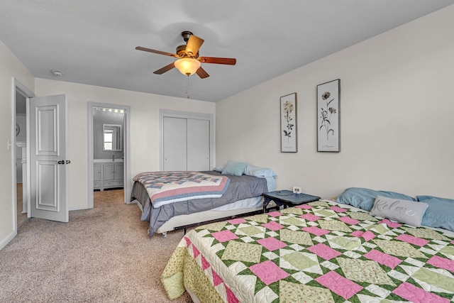 bedroom with connected bathroom, a ceiling fan, a closet, and light colored carpet