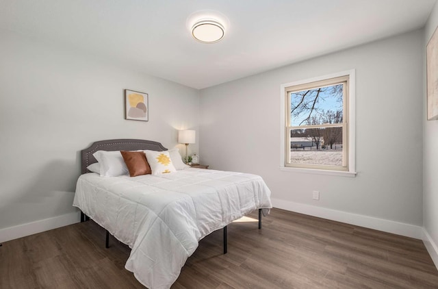 bedroom featuring dark wood-style floors and baseboards