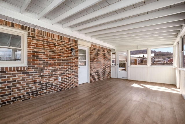 unfurnished sunroom featuring wooden ceiling and beamed ceiling