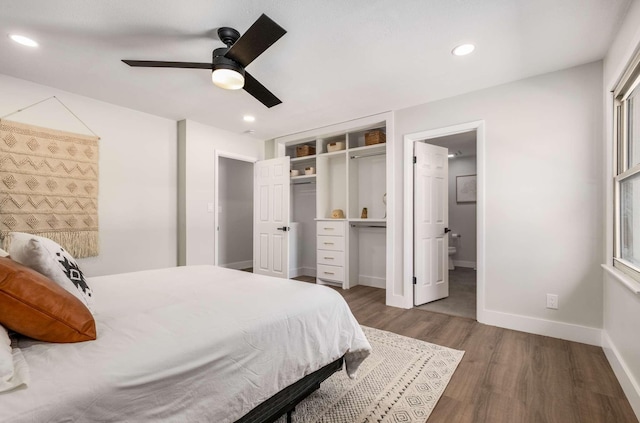 bedroom featuring ceiling fan, recessed lighting, baseboards, dark wood-style floors, and ensuite bath