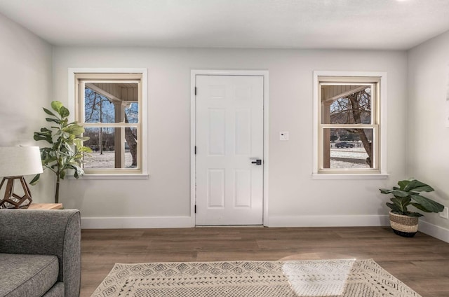 entryway featuring dark wood-style floors and baseboards