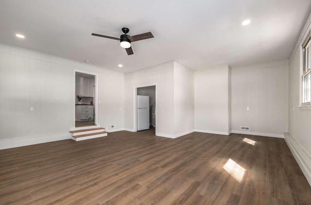 empty room with recessed lighting, visible vents, a ceiling fan, baseboards, and dark wood finished floors