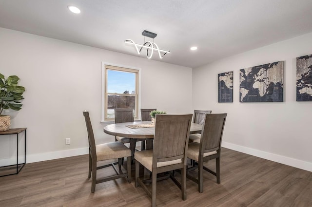 dining area featuring baseboards, dark wood finished floors, and recessed lighting