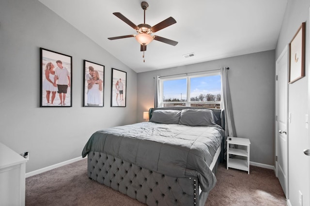 bedroom featuring lofted ceiling, dark carpet, visible vents, and baseboards