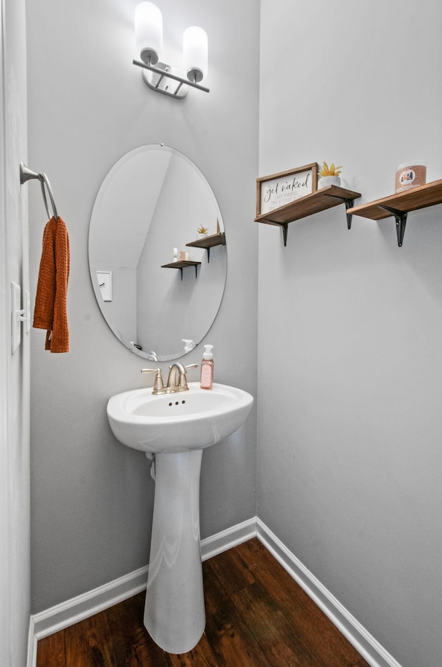 bathroom with wood finished floors and baseboards