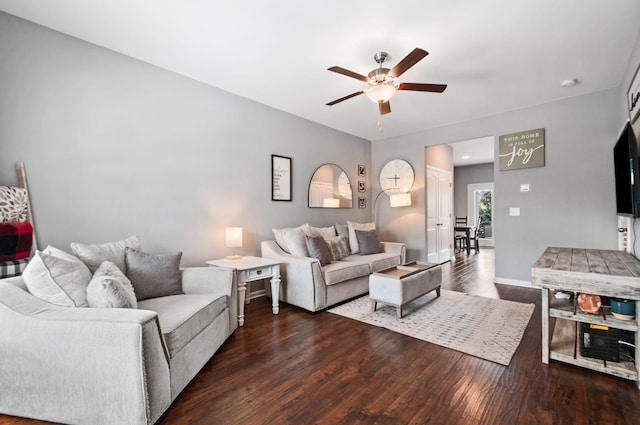 living room featuring ceiling fan, dark wood finished floors, and baseboards