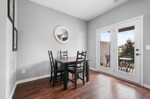 dining room with dark wood-style flooring, visible vents, and baseboards