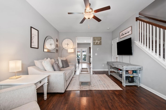 living area with ceiling fan, baseboards, and wood finished floors