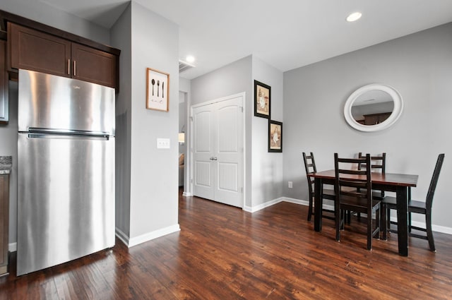 dining area with recessed lighting, dark wood finished floors, visible vents, and baseboards